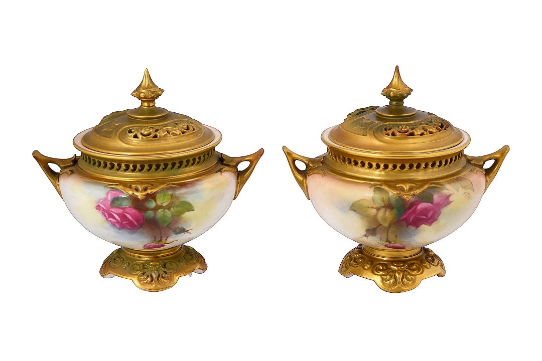 A near pair of Royal Worcester twin handled pot pourri vases and covers
