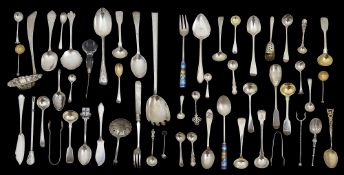 A collection of silver spoons and serving utensils