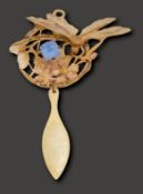 An Art Nouveau hard carved horn pendant by Georges Pierre