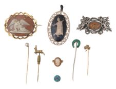 A collection of brooches and stick pins