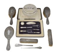 An Edwardian silver dressing set, silver manicure set, silver rimmed bowl