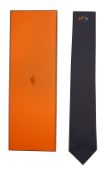 An Hermes navy tie with horse motif