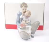 NAO – READ ME A STORY - BOXED CERAMIC FIGURINE