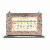 AN ART DECO SILVER AND WOOD DESK CALENDAR
