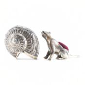 A SILVER CAT PIN CUSHION & A SILVER SHELL VESTA CASE