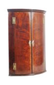 GEORGE III FLAME MAHOGANY VENEERED BOW FRONT CORNER CABINET