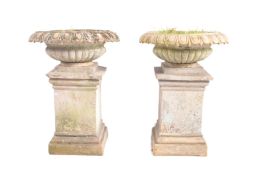 NEO CLASSICAL PAIR OF CLAM SHELL PEDESTAL STONE PLANTERS