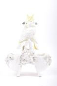 19TH CENTURY COCKATOO ON BASKET FIGURINE GROUP