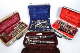 FOUR VINTAGE CLARINETS IN FITTED HARD CASES