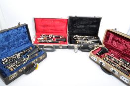 COLLECTION OF FOUR VINTAGE CLARINETS IN FITTED HARD CASES