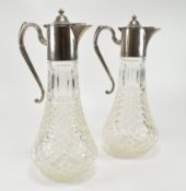 PAIR OF EARLY 20TH CENTURY SILVER PLATED GLASS CLARET JUGS