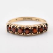 HALLMARKED 9CT GOLD & GARNET SEVEN STONE RING