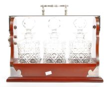 A CONTEMPORARY THREE DECANTER BOTTLE TANTALUS