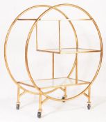 A ROUND ART DECO STYLE GLASS SHELVED DRINKS / BAR TROLLEY