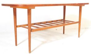 A VINTAGE TEAK WOOD LOW COFFEE TABLE WITH MAGAZINE RACK