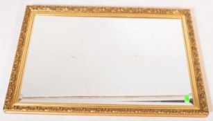 A LARGE VINTAGE GILT FRAMED BEVELLED EDGED MIRROR
