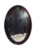 LARGE OVAL EDWARDIAN MAHOGANY WALL MIRROR