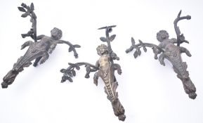 THREE VICTORIAN CAST BRONZE PUTTI WALL LIGHT FITTINGS