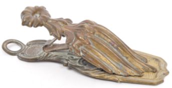 A VICTORIAN BRASS LETTER CLIP BY MERRY PHIPSON AND PARKERS
