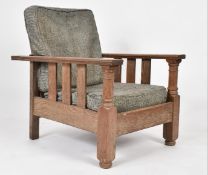 AN ARTS & CRAFTS 20TH CENTURY OAK RECLINING ARMCHAIR