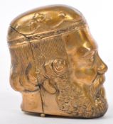 BRASS CASED VESTA & STRIKE IN THE FORM OF A CLASSICAL HEAD