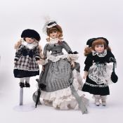 THREE VINTAGE 1990S CHINA DOLLS WEARING DRESSES & RINGLETS