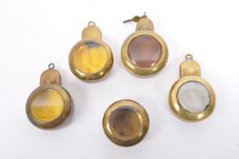 FIVE EARLY 20TH CENTURY SCREW FIT BRASS POCKET WATCH HOLDERS