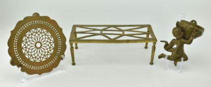 TWO VICTORIAN ARTS & CRAFTS TRIVETS & A WALL CHERUB