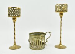 THREE VICTORIAN GOTHIC BRASS CANDLESTICK HOLDERS