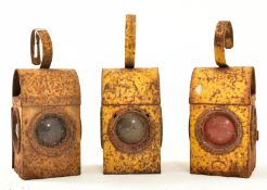 THREE VINTAGE 1970S YELLOW METAL ROAD / RAIL PARAFFIN LAMPS