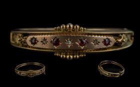 Edwardian Period 1901 - 1910 Attractive 9ct Gold Hinged Bangle set with rubies and diamonds, fully