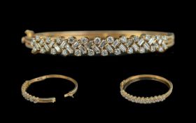 Ladies - Superb Quality 18ct Gold Diamond Set Hinged Bangle. The Step-cut and Brilliant Cut Diamonds