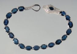 A SILVER SAPPHIRE SET SNAKE BRACELET