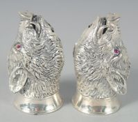 A PAIR OF SILVER PLATED BOAR'S HEAD SALT AND PEPPERS, 6 cm.