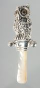 A SILVER OWL RATTLE.