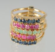 A GOLD PLATED SILVER SAPPHIRE, RUBY, AND EMERALD RING.