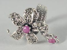 A SILVER MARCASITE RUBY SNAKE RING.