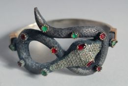 A SILVER AND GILT SNAKE BANGLE, in a heart shaped velvet box.