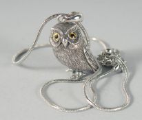 A CAST SILVER OWL PENDANT AND CHAIN.