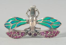 A SILVER RUBY DRAGONFLY RING.
