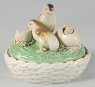 A POTTERY CHICK ON A BASKET, 18 cm long.