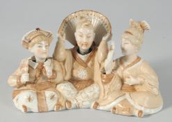A POTTERY GROUP OF THREE NODDING CHINESE FIGURES, 19 cm long.