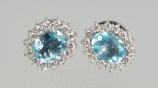 A SUPERB PAIR OF 18ct. WHITE GOLD AQUAMARINE AND DIAMOND CLUSTER EARRINGS.