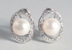 A PAIR OF SILVER AND PEARL EARRINGS.