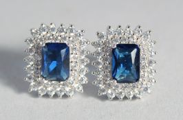 A PAIR OF SILVER FAUX SAPPHIRE EAR STUDS.