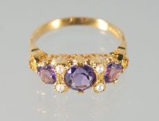 A SILVER AND GOLD PLATED AMETHYST AND PEARL RING.