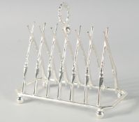 A SILVER PLATED CROSSED GUNS TOAST RACK.