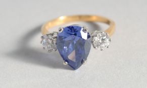 A SILVER GOLD PLATED, PEAR SHAPED, FAUX TANZANITE AND CUBIC ZIRCONIA RING.