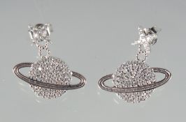 A PAIR OF SILVER PLANET EARRINGS.