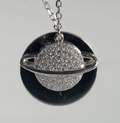 A SILVER PLANET PENDANT AND CHAIN.